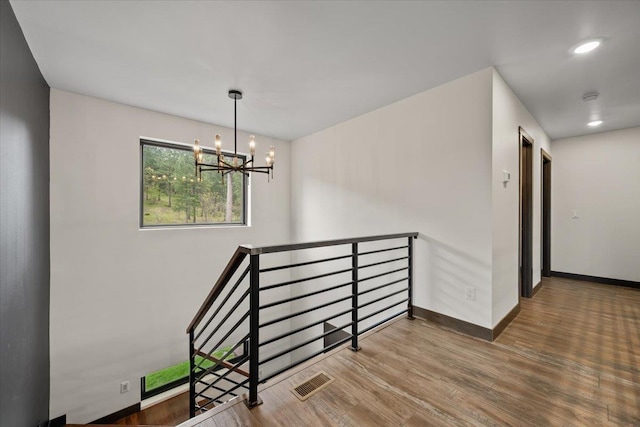 3135 American Eagle Rd, Spearfish, SD 57783 - stairway with wood finished floors, a chandelier, and baseboards