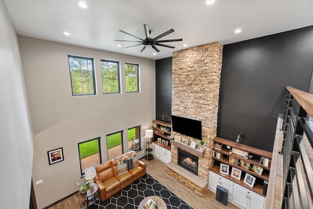 3135 American Eagle Rd, Spearfish, SD 57783 - living room featuring a stone fireplace, a ceiling fan, recessed lighting, and wood finished floors