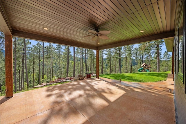 3135 American Eagle Rd, Spearfish, SD 57783 - view of patio with a playground, a ceiling fan, and a forest view