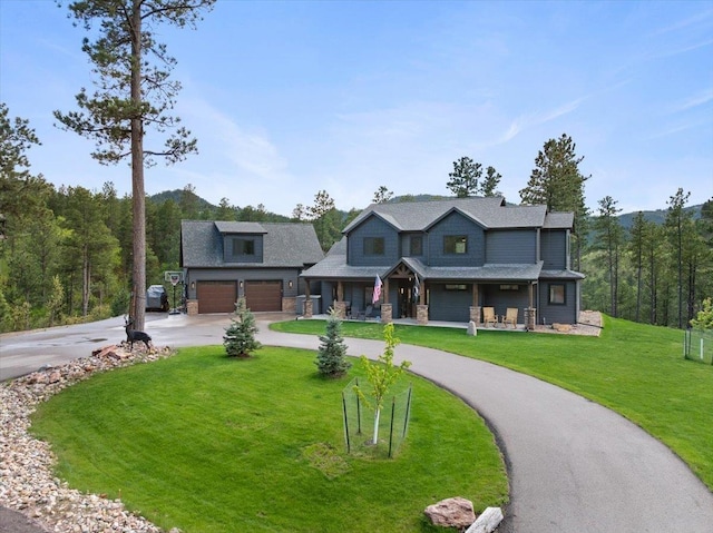 3135 American Eagle Rd, Spearfish, SD 57783 - craftsman house with curved driveway, covered porch, a front lawn, and stone siding