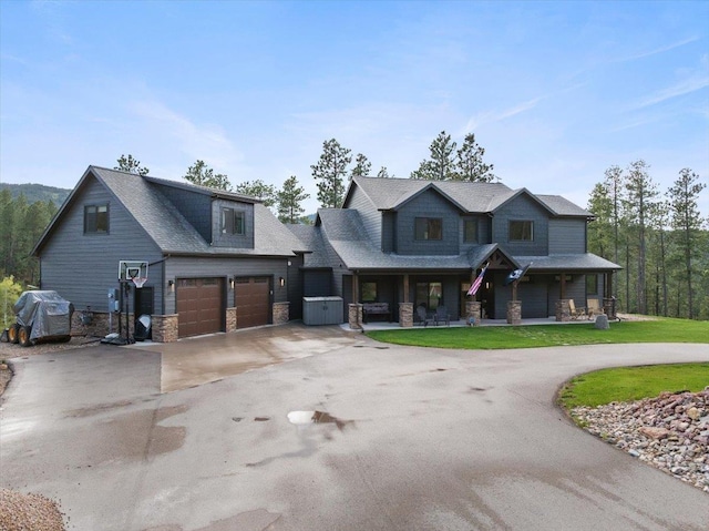 3135 American Eagle Rd, Spearfish, SD 57783 - craftsman house with curved driveway, covered porch, stone siding, and an attached garage