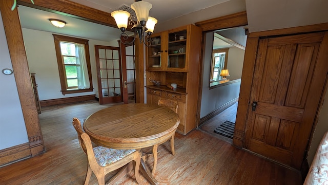57 Lincoln Ave, Deadwood, SD 57732 - dining area with wood finished floors, a chandelier, and baseboards