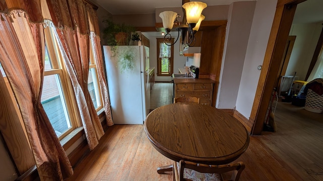 57 Lincoln Ave, Deadwood, SD 57732 - dining room featuring light wood-type flooring, a chandelier, and baseboards