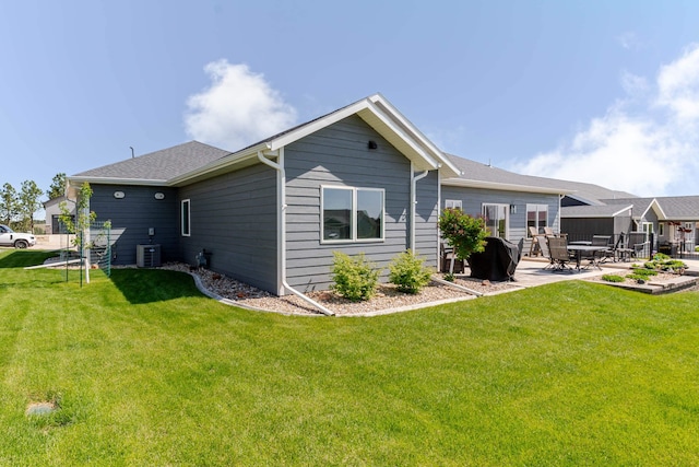 4413 Targhee Dr, Rapid City, SD 57702 - rear view of property featuring a patio, a lawn, and central AC unit