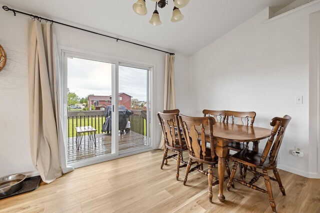 491 Freude Ln, Box Elder, SD 57719 - dining room with a chandelier, vaulted ceiling, and wood finished floors