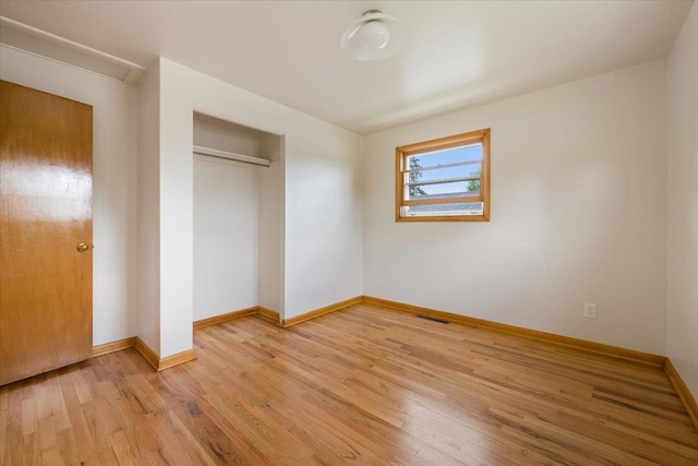 1041 State St, Spearfish, SD 57783 - unfurnished bedroom with light wood-style flooring, baseboards, and a closet