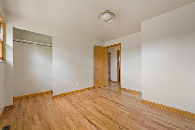 1041 State St, Spearfish, SD 57783 - unfurnished bedroom featuring light wood-style flooring, baseboards, and a closet