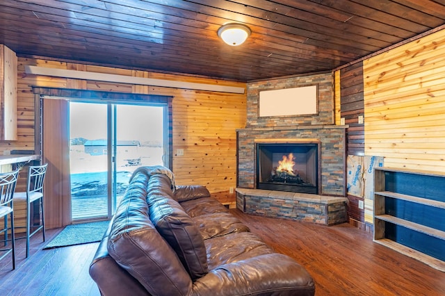 25426 Sidney Park Rd, Custer, SD 57730 - living room with wood ceiling, wood walls, hardwood / wood-style floors, and a stone fireplace