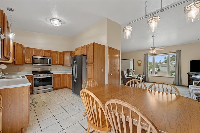 1006 S 33rd St, Spearfish, SD 57783 - kitchen featuring appliances with stainless steel finishes, a sink, open floor plan, light countertops, and light tile patterned floors