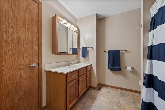 1006 S 33rd St, Spearfish, SD 57783 - full bath featuring vanity, baseboards, and toilet