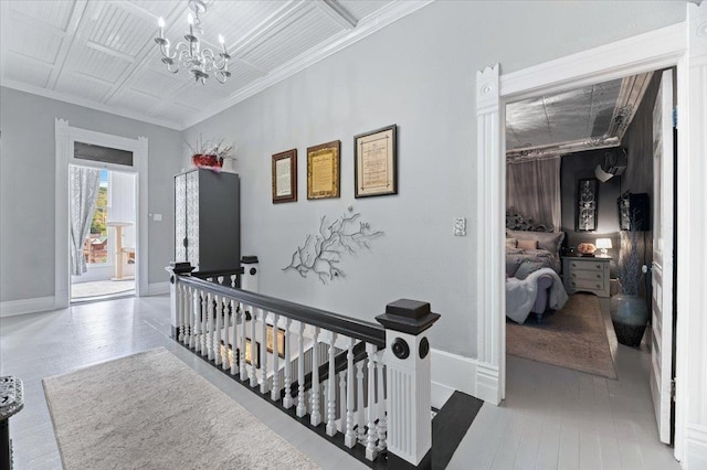 1231/2 Stone St, Lead, SD 57754 - hallway with an upstairs landing, a chandelier, ornamental molding, and baseboards