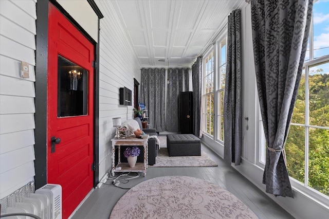 1231/2 Stone St, Lead, SD 57754 - sunroom / solarium with plenty of natural light, wood finished floors, radiator, and wooden walls