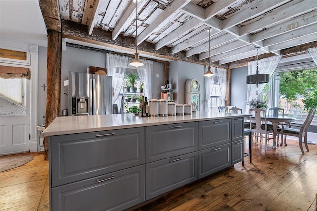 1231/2 Stone St, Lead, SD 57754 - kitchen with gray cabinets, stainless steel refrigerator with ice dispenser, wood-type flooring, healthy amount of natural light, and beam ceiling