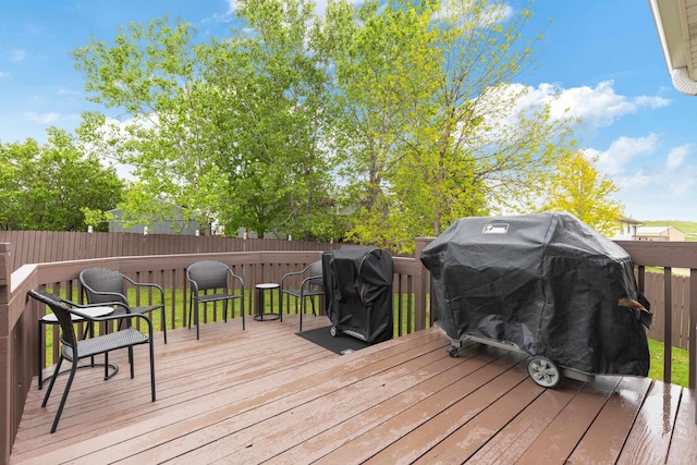 4312 Mile High Ave, Rapid City, SD 57701 - wooden deck featuring a grill and a fenced backyard