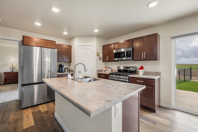 516 Aaron Ct, Rapid City, SD 57703 - kitchen with stainless steel appliances, a sink, dark wood-type flooring, light countertops, and recessed lighting