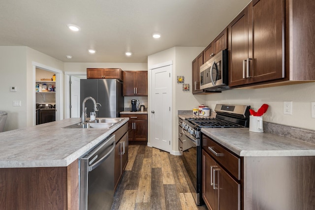 516 Aaron Ct, Rapid City, SD 57703 - kitchen with appliances with stainless steel finishes, a sink, independent washer and dryer, dark wood finished floors, and recessed lighting