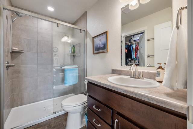 516 Aaron Ct, Rapid City, SD 57703 - bathroom with vanity, tiled shower, toilet, and a spacious closet