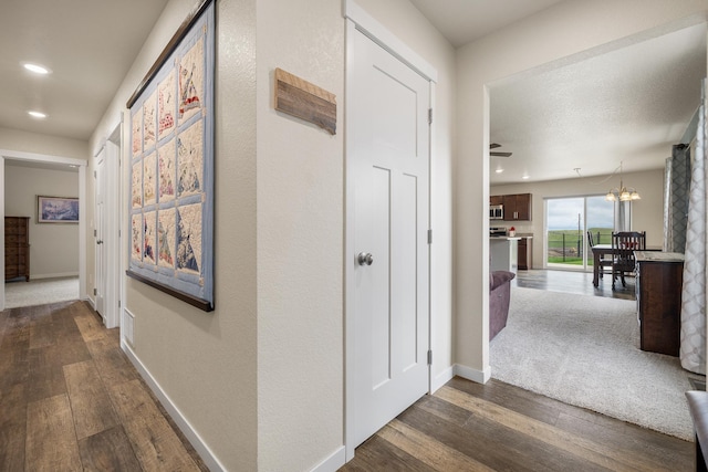 516 Aaron Ct, Rapid City, SD 57703 - corridor with dark wood-style flooring, recessed lighting, baseboards, and a chandelier