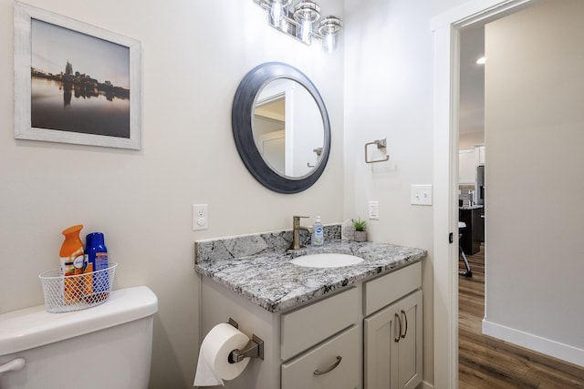 2259 Suntory Ave, Spearfish, SD 57783 - bathroom featuring toilet, wood finished floors, vanity, and baseboards
