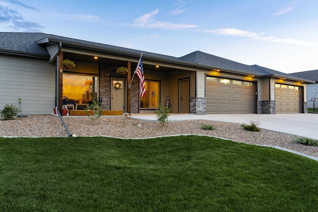 2259 Suntory Ave, Spearfish, SD 57783 - view of front of house with a garage, a front yard, driveway, stone siding, and roof with shingles