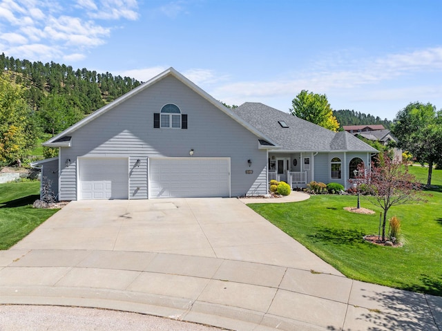 2340 Camaro Cir, Sturgis, SD 57785 - view of front of house featuring a porch, a front yard, driveway, and a garage