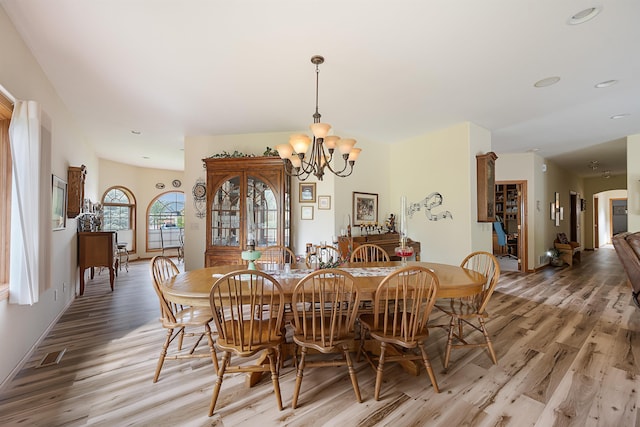 2340 Camaro Cir, Sturgis, SD 57785 - dining space with light wood finished floors, a chandelier, and baseboards