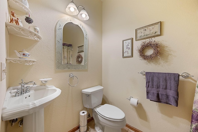2340 Camaro Cir, Sturgis, SD 57785 - full bathroom with toilet, tile patterned flooring, baseboards, and a sink