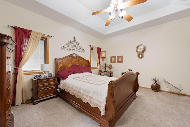2340 Camaro Cir, Sturgis, SD 57785 - bedroom featuring light carpet, baseboards, a tray ceiling, and ceiling fan
