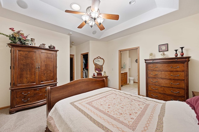 2340 Camaro Cir, Sturgis, SD 57785 - bedroom with a tray ceiling, ensuite bath, a ceiling fan, and baseboards
