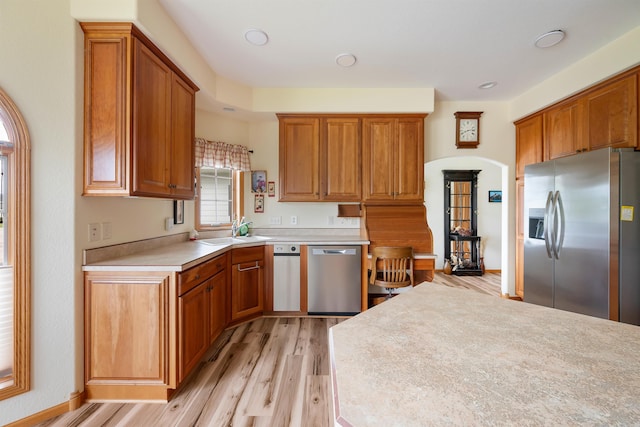 2340 Camaro Cir, Sturgis, SD 57785 - kitchen with appliances with stainless steel finishes, light wood-type flooring, light countertops, brown cabinets, and a sink