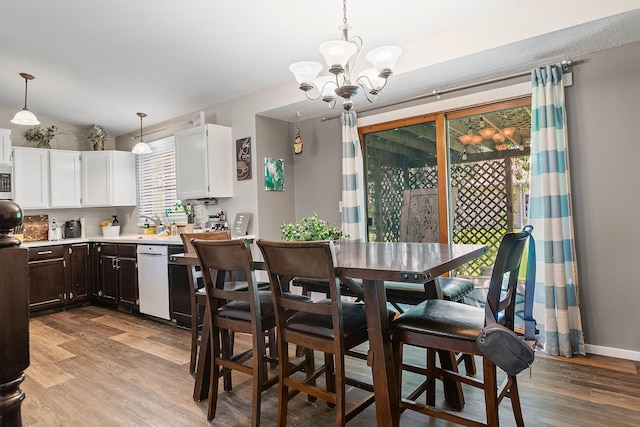 3111 Dry Creek Rd, Rapid City, SD 57703 - dining space with a chandelier, light wood-type flooring, and baseboards