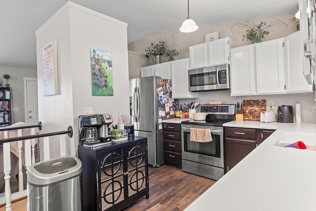 3111 Dry Creek Rd, Rapid City, SD 57703 - kitchen with stainless steel appliances, white cabinets, dark wood-type flooring, light countertops, and a sink