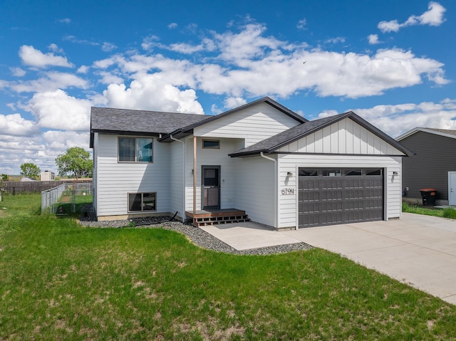 6794 Abelia St, Rapid City, SD 57703 - view of front of property with a garage, concrete driveway, board and batten siding, and roof with shingles