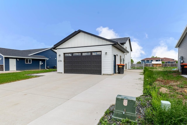 6794 Abelia St, Rapid City, SD 57703 - view of front of property featuring a garage, board and batten siding, and concrete driveway