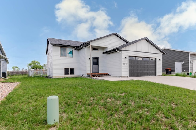 6794 Abelia St, Rapid City, SD 57703 - view of front of house featuring a garage, concrete driveway, and board and batten siding