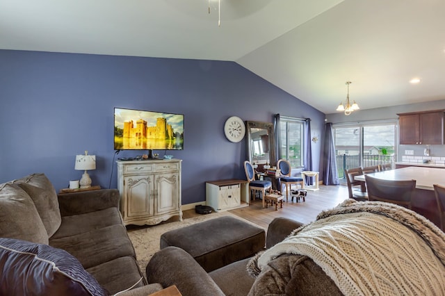 6794 Abelia St, Rapid City, SD 57703 - living room with lofted ceiling, a chandelier, light wood finished floors, and ceiling fan
