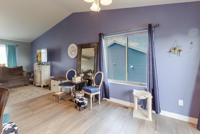 6794 Abelia St, Rapid City, SD 57703 - dining space with vaulted ceiling, wood finished floors, and baseboards