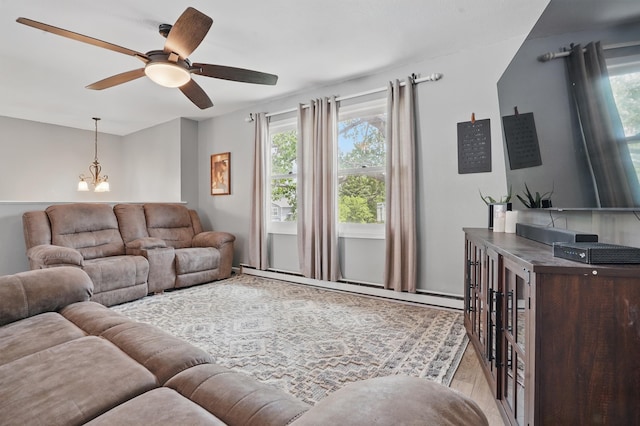 4425 Bronco Ln, Rapid City, SD 57701 - living room with healthy amount of natural light, a baseboard heating unit, ceiling fan, and a chandelier