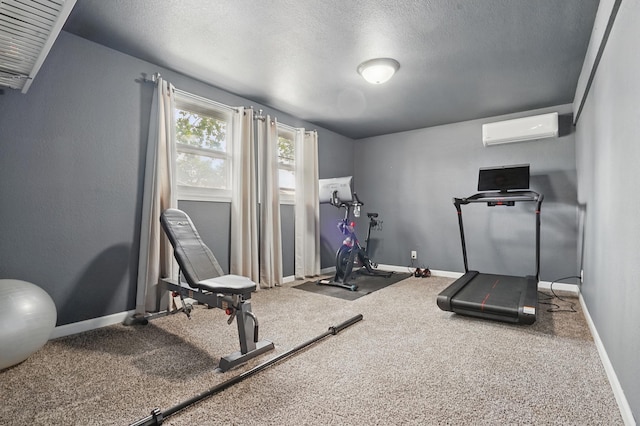 4425 Bronco Ln, Rapid City, SD 57701 - exercise room with an AC wall unit, a textured ceiling, and baseboards