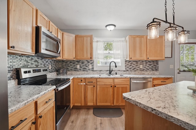 4425 Bronco Ln, Rapid City, SD 57701 - kitchen featuring appliances with stainless steel finishes, a sink, light wood finished floors, light brown cabinets, and decorative backsplash