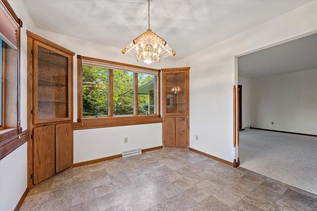 614 Englewood Ct, Spearfish, SD 57783 - unfurnished room featuring a chandelier, baseboards, and stone finish floors