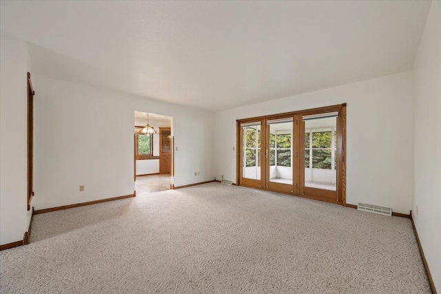 614 Englewood Ct, Spearfish, SD 57783 - unfurnished room with light colored carpet, baseboards, and a chandelier