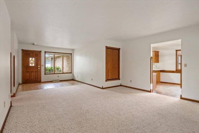 614 Englewood Ct, Spearfish, SD 57783 - unfurnished living room featuring light carpet and baseboards