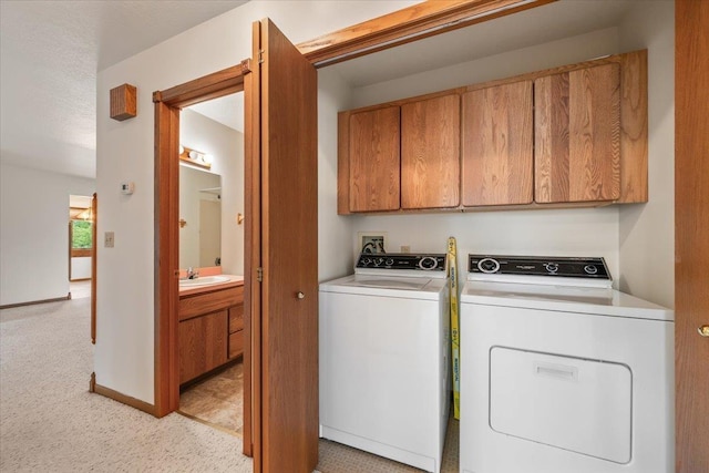 614 Englewood Ct, Spearfish, SD 57783 - laundry room featuring independent washer and dryer, cabinet space, light colored carpet, and baseboards
