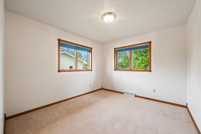 614 Englewood Ct, Spearfish, SD 57783 - unfurnished room with carpet flooring, baseboards, and a textured ceiling