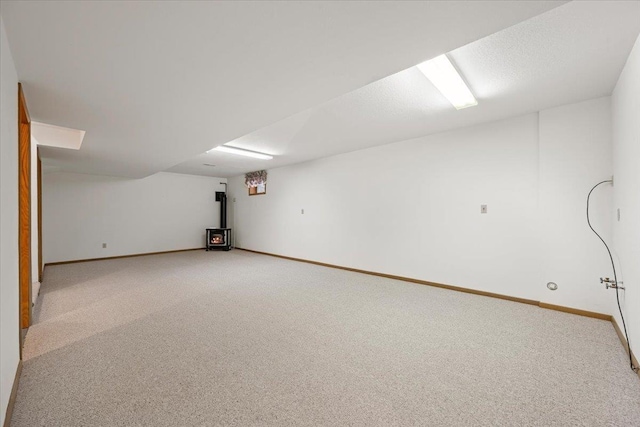 614 Englewood Ct, Spearfish, SD 57783 - finished basement featuring light colored carpet, baseboards, and a wood stove