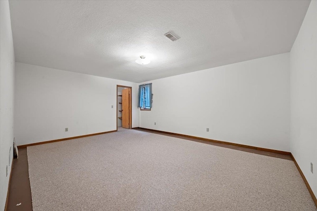 614 Englewood Ct, Spearfish, SD 57783 - carpeted empty room with baseboards and a textured ceiling