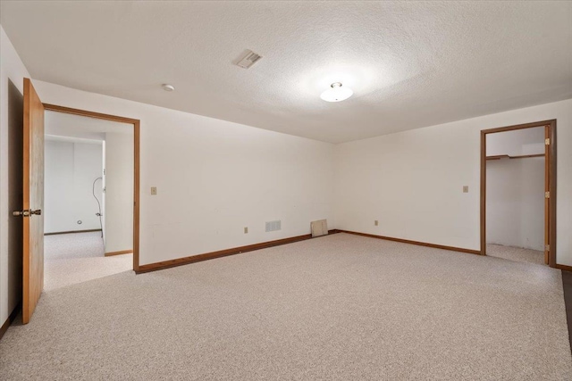 614 Englewood Ct, Spearfish, SD 57783 - unfurnished bedroom with light carpet, baseboards, and a textured ceiling