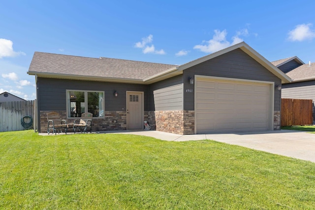 4961 Savannah St, Rapid City, SD 57703 - view of front facade featuring a garage, driveway, a shingled roof, and stone siding