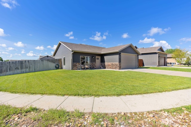4961 Savannah St, Rapid City, SD 57703 - single story home with concrete driveway, a garage, stone siding, and roof with shingles